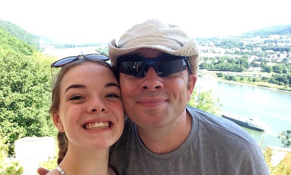 Father and daughter on holiday both smiling